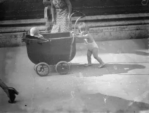 Piccadilly heat wave parade. In the briefest of bathing costumes this little girl