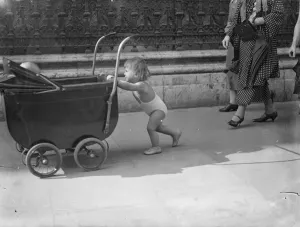 Piccadilly heat wave parade. In the briefest of bathing costumes this little girl