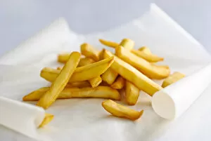 Vegetable Collection: Pile of french fries on greaseproof paper credit: Marie-Louise Avery / thePictureKitchen