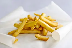 Board Prints: Pile of french fries on greaseproof paper credit: Marie-Louise Avery / thePictureKitchen