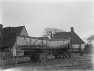 A policeman builds a boat on the village green in Faversham, Kent. 1937