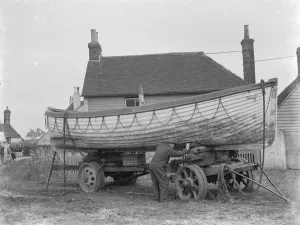 A policeman builds a boat on the village green in Faversham, Kent. 1937