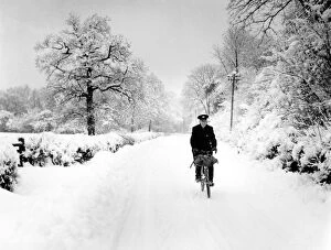Winter Collection: Postman cycling through snow in Bough Beech, Kent. 28th December 1962
