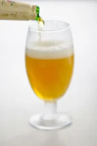 Alcohol Prints: Pouring lager beer into stemmed beer glass credit: Marie-Louise Avery / thePictureKitchen