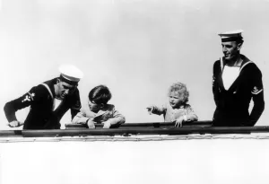 Prince Charles and Princess Anne on board the Royal yacht Britannia sailing into