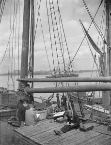 Youth Prints: Pupils from the art school sit on the deck of a Thames Barge drawing pictures in