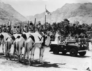 Monarch Prints: Queen Elizabeth II cool and unruffled in spite of the heat stands with the Duke