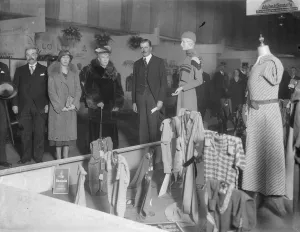 Queen watches fashion parade at British textile exhibition. The Queen, accompanied