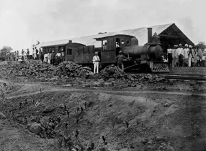 Colonial Prints: Railway station with steam train. Bricks can be seen that built the platform