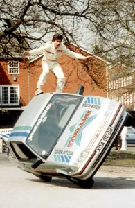 Danger Prints: Randy perched on the door of two-wheeled driven car - ?TopFoto