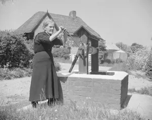 Elderly Prints: Rebecca Munday using a water well in Deans Bottom, Kent. 1939