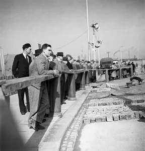The rebuilding of Coventry City, England Citizens watch men at work, relaying