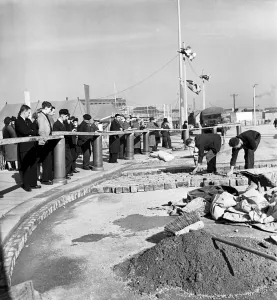 Bricks Prints: The rebuilding of Coventry City, England Citizens watch men at work, relaying