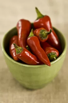 Bowls Collection: Red hot chilli peppers in green bowl credit: Marie-Louise Avery / thePictureKitchen