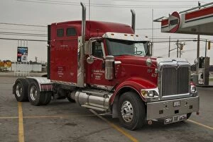 Trucks Collection: Red International eagle 6 x4 semi at a service station on the outskirts of the