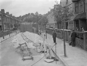 Residents of a street in Plumstead look at what is left of their road following some subsidence