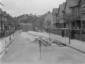 Suburbia Prints: Residents of a street in Plumstead look at what is left of their road following some subsidence