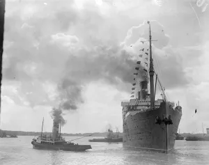 The RMS Berengaria sails with the Prince of Wales on board. The beflagged liner
