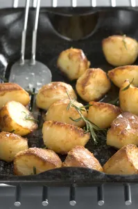 Bowl Prints: Roast potatoes in black roasting tin with salt and rosemary credit: Marie-Louise