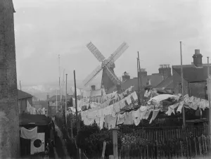 Rochester windmill in Kent, seen from behind the washing lines. 1936