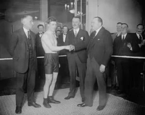 Roland Todd ( stripped ) shaking hands with the Manager of the Savoy Hotel. On