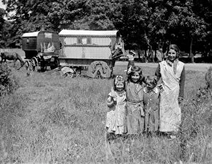 Children Collection: Romany gypsy girls posing outside their caravans on Epsom Downs during the Epsom