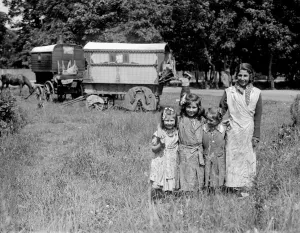 Romany gypsy girls posing outside their caravans on Epsom Downs during the Epsom