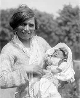 1950s Collection: A Romany gypsy mother holds her baby at the Epsom Races. Late 1940s, early 1950s
