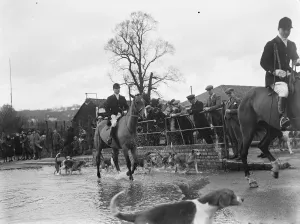 The Royal Artillery Drag Hunt cross a flooded street in Eynsford, Kent