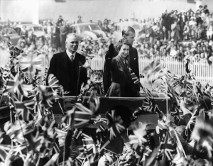 Smiling Prints: The Royal Tour The Queen and The Duke surrounded by a mass of children waving flags