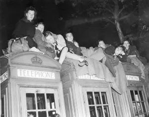 Royal Wedding. People determined to get a good view photographed on top of telephone boxes