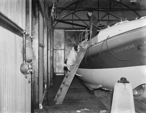 A sailor and a cocker spaniel on board a Dungeness life boat in Kent. 1939