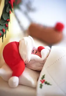 Decorative Prints: Santa and Rudolph the red-nosed reindeer sleeping in bed made of icing - Christmas