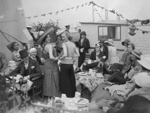 Scenes on board showboat on Thames. Mannequins displaying beach wear