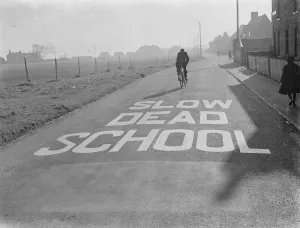 Education Prints: A school sign painted on the road warning road users they are approaching a school area