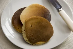 Sweet Prints: Three Scotch pancakes on a white plate. credit: Marie-Louise Avery / thePictureKitchen
