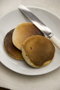 Three Scotch pancakes on a white plate. credit: Marie-Louise Avery / thePictureKitchen