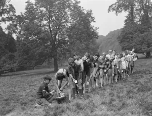 Scouts at Bexley scouts camp. The scouts line up to get a drink. 1937