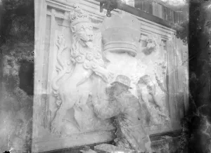 A sculptor working on a heraldic base relief [Royal Supporters of England / Royal Arms of England