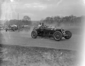 Seaman driving single handed, wins British Empire road race. Driving witout relief