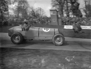Seaman driving single handed, wins British Empire road race. Driving witout relief