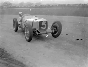 Seaman driving single handed, wins British Empire road race. Driving witout relief