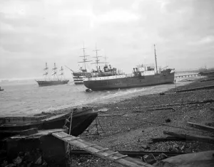 Masts Prints: Shipping run aground on the shore in front of HMS Worcester and The Cutty Sark