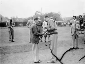Golfer Prints: Sidcup Golf Clubs new captain Mr A J Barnes (right) gives a gift to his caddy W Hamer