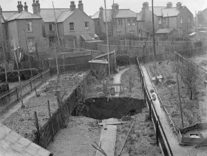 Suburbia Prints: A sinkhole has opened up in peoples gardens in Dartford, Kent. 1937