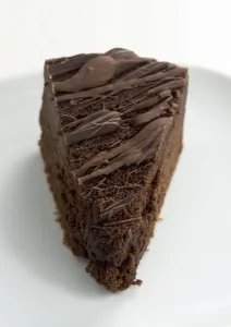 Dessert Prints: Slice of rich dark chocolate cake with melted chocolate topping credit: Marie-Louise