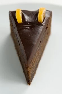 Inspiration Collection: Slice of rich dense dark chocolate cake with shiny choc topping and candied orange