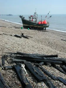 Small fishing boat moored on seashore, Walmer, Kent, England