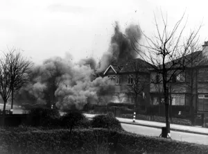 London Life Prints: Smoke and debris thrown skywards after a direct hit from a German bomb in the suburbs