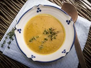 Recipe Collection: Soup of squash roasted with garlic and thyme, served in blue and white bowl with